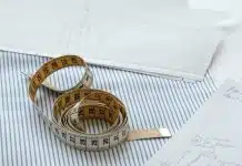 gold and silver bracelet on white paper